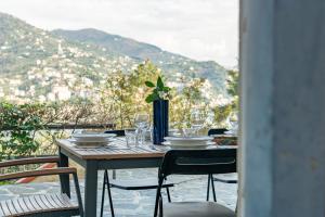 a table with glasses and plates on it with a view at Villa Chichizola in Rapallo