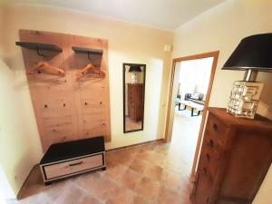 a room with a wooden wall with a dresser and a mirror at Ferienhaus Ditzum am Sielblick in Ditzum