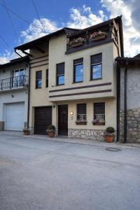 a large house with potted plants in front of it at Prestige Old Town Villa in Sarajevo