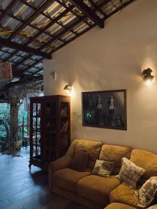 a living room with a couch and a picture on the wall at Pousada Aguas Marinhas in Cabo de Santo Agostinho
