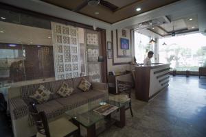 a man standing at a counter in a living room at Rani Palace Hotel And Resort in Kishangarh