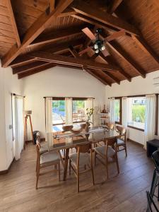 a dining room with a table and a ceiling fan at Estancia de Cafayate Wayra Huasi in Cafayate