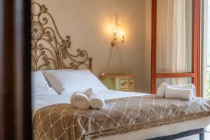 a bedroom with a bed with towels on it at Villa Chichizola in Rapallo
