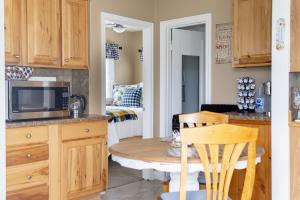 a kitchen with a table and a microwave at Our Little Yellow House in Saint Anthony