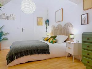 a bedroom with a bed and a green dresser at La Courette des Rois - Hyper centre & Chateau in Dourdan