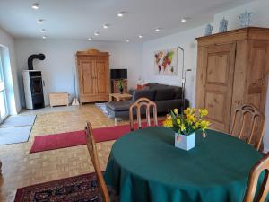 a living room with a table and a couch at Ferienhaus Ottilie in Gladenbach
