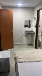 a bathroom with a sink and a mirror at HotelItaveraMS in Campo Grande +5 photos