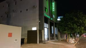 a building with a green sign on the side of it at HotelItaveraMS in Campo Grande