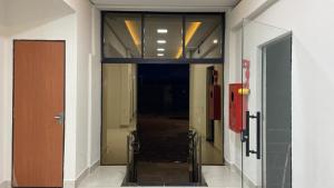 a hallway with a glass door in a building at HotelItaveraMS in Campo Grande
