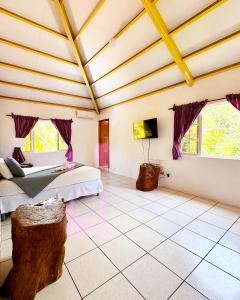 a large room with two beds and a wooden ceiling at Venecia Yatch Club in San Luis La Herradura
