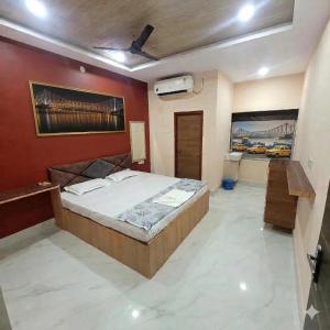 a bedroom with a large bed and a red wall at The Rasoi Retreat in Majnān
