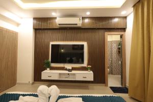 a living room with a television and a sink at Navrasa By CDF in Vrindāvan