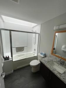 a bathroom with a shower and a toilet and a sink at Sechelt inn in Sechelt +49 photos