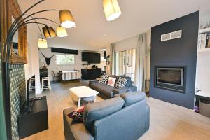 a living room with a couch and a table at Maison Capucine in Hossegor