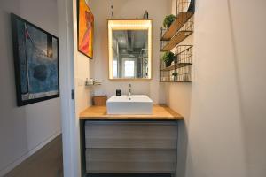 a bathroom with a sink and a mirror at Maison Capucine in Hossegor +37 photos