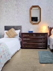 a bedroom with a bed and a dresser with a mirror at Altobello Venice Apartment in Mestre
