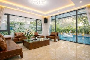 a living room with a pool and a swan at Villa FLC Sầm Sơn Đức Anh in Sầm Sơn