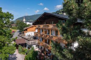 an aerial view of a building with palm trees at Pension Mayerhofer in Piesendorf