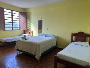 a bedroom with two beds and a window at Hotel Ideal in Boa Vista