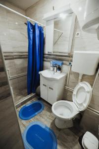 a bathroom with a toilet and a sink and a mirror at LUX Apartman Jugi PARKING public free in Novi Pazar +18 photos
