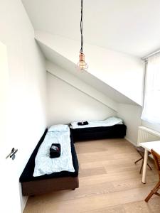 a room with two beds in the attic at Modern Two-Bedroom Apartment with Sauna & Free Parking in Turku