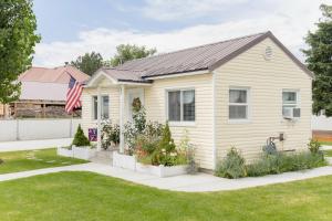 a house with a garden in the front yard at Our Little Yellow House in Saint Anthony