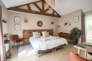 a bedroom with a large bed and a desk at Domaine Kaet in Ratenelle +65 photos