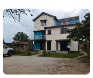 a person standing in front of a house at villa EMMANUEL -2 in Belanitra