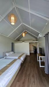 a large room with two beds and a desk and a table at Secret Terrace Pool Villa Rayong in Ban Bua Phut +21 photos