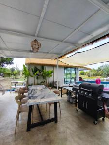 a pool room with tables and ping pong tables at Secret Terrace Pool Villa Rayong in Ban Bua Phut