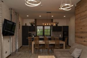a kitchen and dining room with a table and chairs at Finlandia Chalet in Bukovel