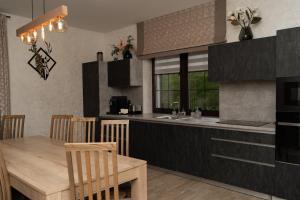 a kitchen and dining room with a table and a kitchen gmaxwell gmaxwell gmaxwell at Finlandia Chalet in Bukovel
