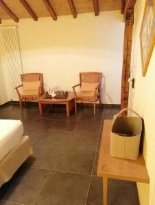 a living room with two chairs and a couch at Masoe des Chatards in Neuilly-le-Réal +38 photos