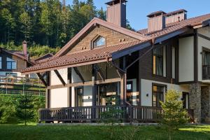 a large house with a wrap around porch at Finlandia Chalet in Bukovel