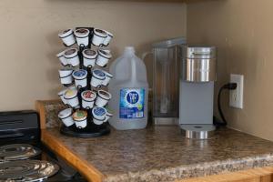 a counter with a bottle of milk and coffee cups at Our Little Yellow House in Saint Anthony +11 photos