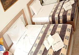 a bed with a comforter on top of it at Elias Home in Volos +33 photos