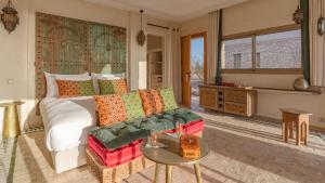 a bedroom with a bed and a couch and a table at Anima Ocean Lodges in Essaouira +64 photos