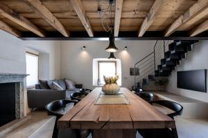 a living room with a wooden table and a couch at Al Crotto in Chiavenna