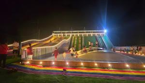 a group of people playing on a playground at night at Okay Marina Lumut Homestay in Lumut