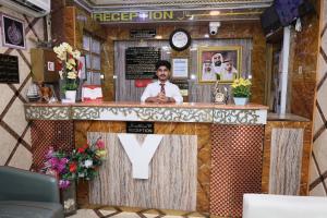 a man sitting at a bar in a restaurant at Al Khaima Hotel in Dubai