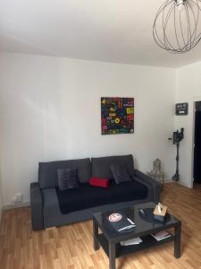 a living room with a couch and a table at Les Cerisiers - Une escale comme à la maison - in Damparis +46 photos