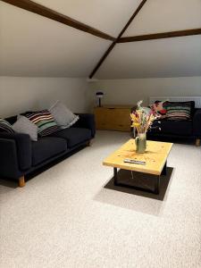 a living room with two couches and a coffee table at Worlaby Coach House in Worlaby