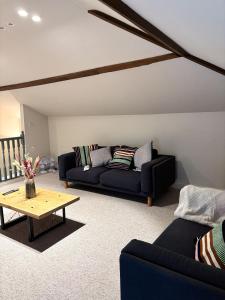 a living room with a couch and a coffee table at Worlaby Coach House in Worlaby