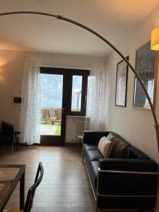 a living room with a couch and a table at Cà Serena Panoramic Garden - Appartamento Greta in Ledro +33 photos