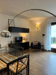 a living room with a table and a couch at Cà Serena Panoramic Garden - Appartamento Greta in Ledro
