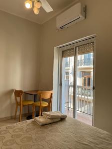a bedroom with a table and chairs and a window at Hotel Europa in Buenos Aires