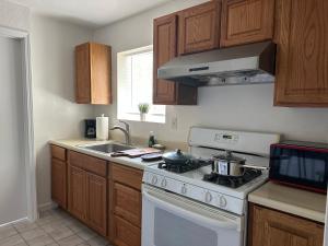 a kitchen with a white stove and a sink at Suite A with a kitchen in Sacramento