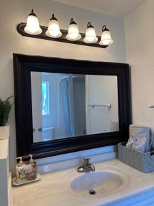 a bathroom sink with a large mirror above it at Suite A with a kitchen in Sacramento