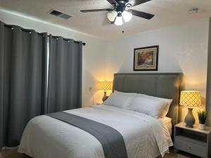 a bedroom with a bed with a ceiling fan at Suite A with a kitchen in Sacramento
