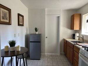 a kitchen with a small table and a refrigerator at Suite A with a kitchen in Sacramento +8 photos